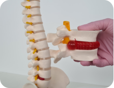 A young man is standing on a tennis court holding his shoulder and grimacing in pain. In his other hand he is holding a tennis racquet.