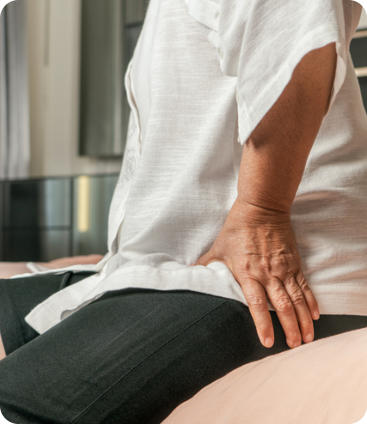 A senior man running through the surf on a tropic beach. He has a surfboard under his arm.