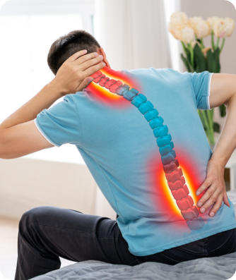 The back of a man who is holding his neck and lower back in pain. The spine is graphically represented with the painful areas marked in red.